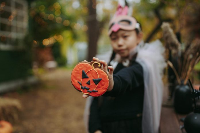 image-23 Boy in Black Suit Holding Jack O Lantern Cookie