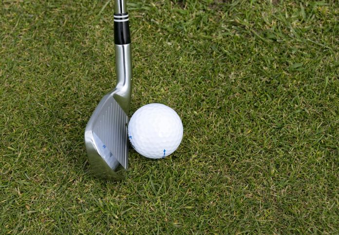 image-36 Silver Wedge Golf Club Beside Ball