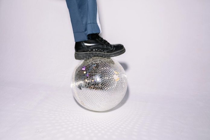 image-75 Close-up of a Person Putting Their Leg on Top of a Disco Ball