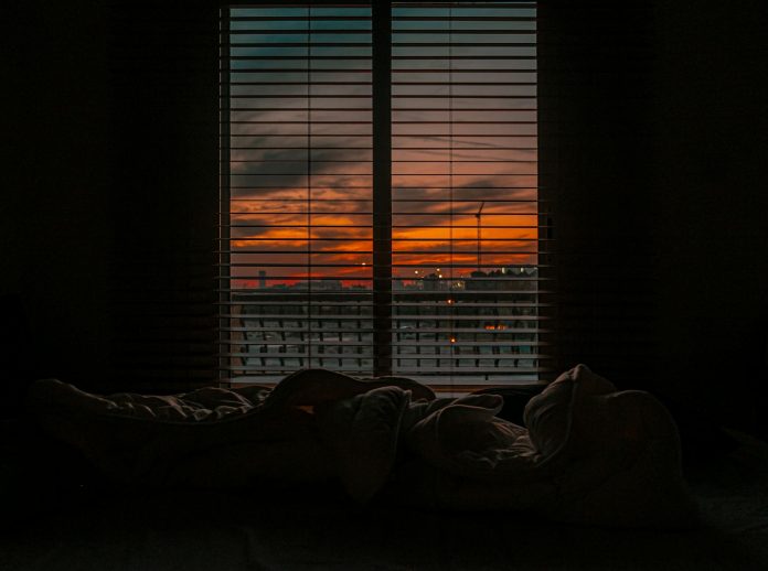 image-85 Crumpled blanket in dark room at sunset