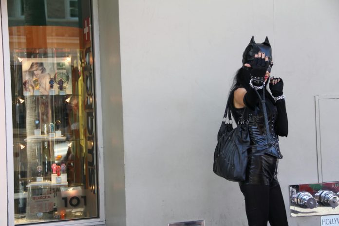 image-106 Woman Leaning on Wall Wearing Black Cat Costume