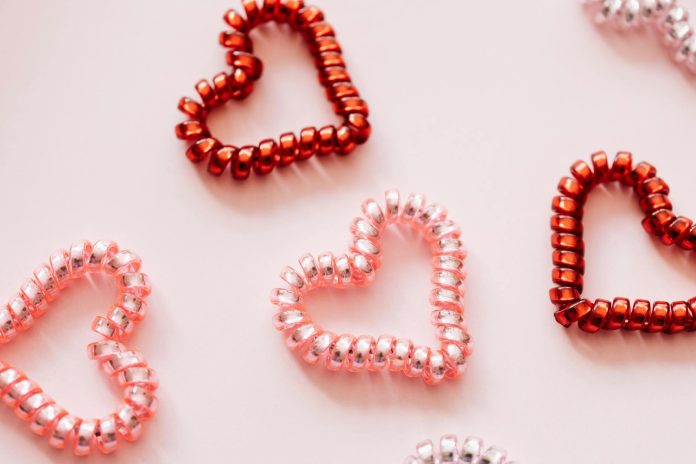 image-142 Colorful hair ties in shape of hearts on pink surface