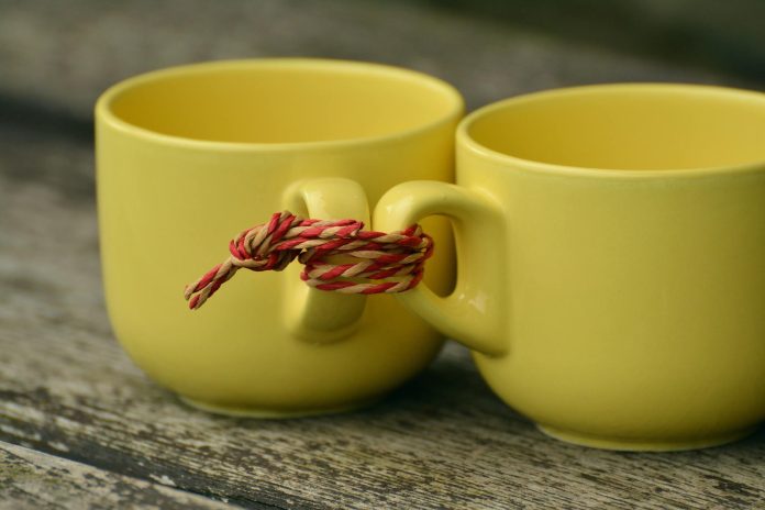 image-46 Two Yellow Mugs Tied Together With Rope