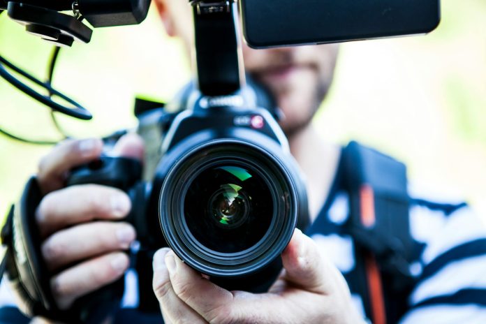 image-49 Person Holding Canon Dslr Camera Close-up Photo