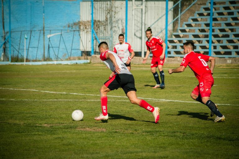 A group of men playing soccer on a field
