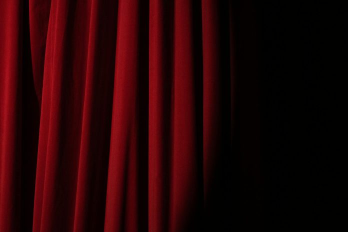 image Spotlight on a Red Curtain