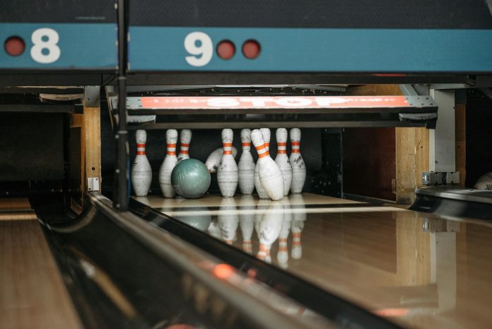 image-76 White and Red Bowling Pins with Green Bowling Ball