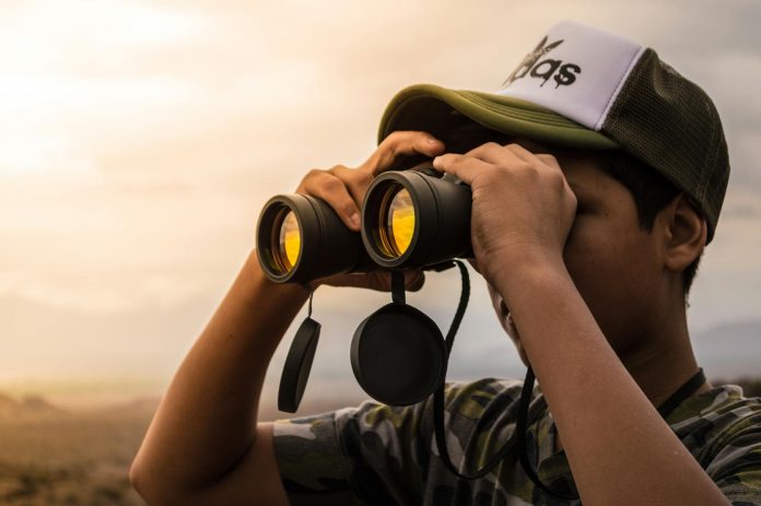image-79 Man Looking in Binoculars during Sunset