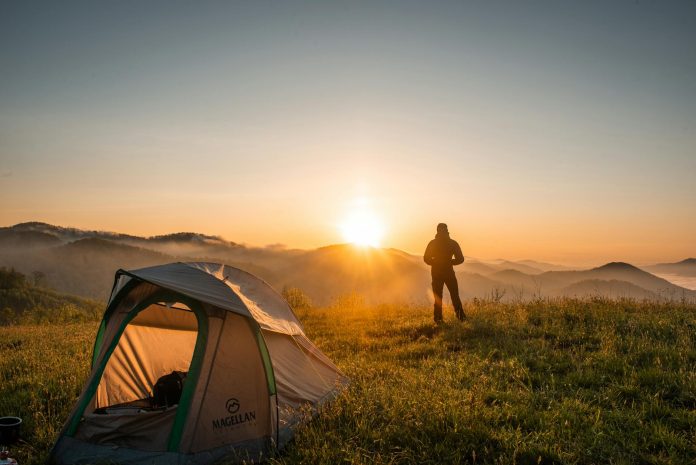 image-20 Silhouette of Person Standing Near Camping Tent