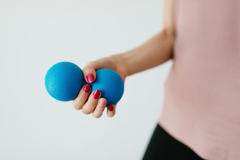 Faceless young woman with stress ball on white background
