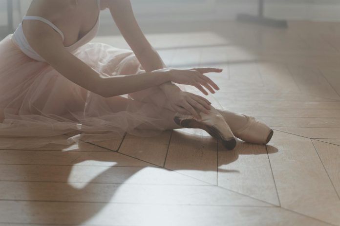 image-29 Pastel Image of a Ballerina Sitting on a Wooden Floor